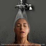 A person with closed eyes stands under a streaming shower. Text: "Start your day dynamically with an energizing shower!