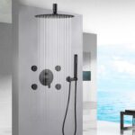 A modern shower with a square overhead, side jets, and handheld, set in a sleek bathroom with an ocean view.