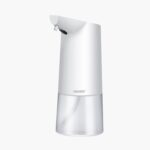 A white automatic soap dispenser with a transparent compartment and top nozzle.