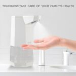 A hand under a touchless soap dispenser. Text: "Touchless care for your family