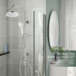 Modern bathroom with glass shower, rain shower set (large overhead and handheld). Round mirror and blue bottle in the background.