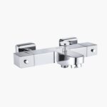 Wall-mounted chrome faucet with square handles and dual outlets.