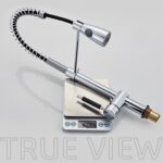 A chrome kitchen faucet with a spring spout, pull-down spray head, and single handle weighs 4.48 lbs on a digital scale. "TRUE VIEW" is visible.