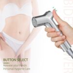 A hand holds a silver bidet sprayer with a button. A person in white underwear is partially visible. Text: "BUTTON SELECT. Personal Hygiene Care.