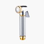 A handheld bidet sprayer with a golden accent, ribbed silver handle, and perforated spray head.