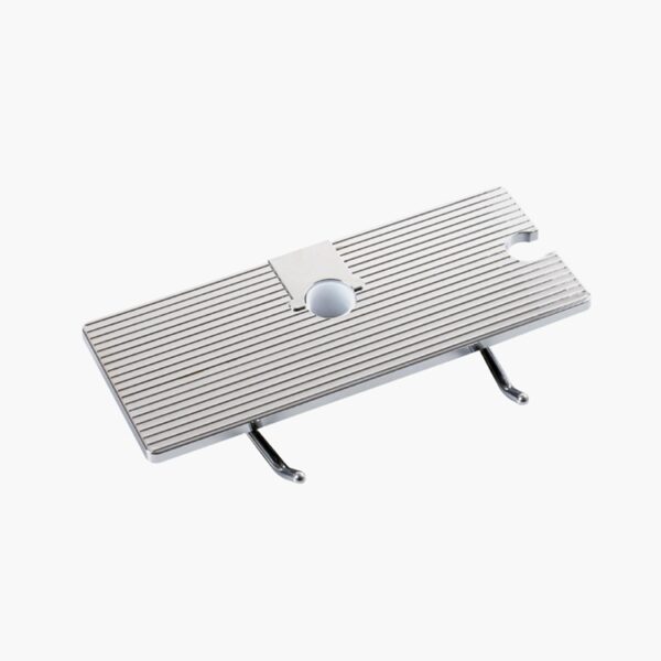 A rectangular metal footrest with ridges and two foldable legs for ergonomic support.