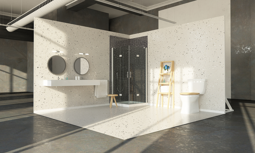 A modern bathroom with a shower, dual round mirrors above a floating sink, wooden stool, toilet, white speckled walls, and gray floor.