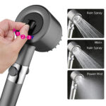 Adjusting a showerhead with three spray settings: Rain, Mist+Rain, and Power Mist.