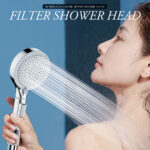 A woman uses a handheld shower head with water streaming over her face. Text reads "FILTER SHOWER HEAD" and "FILTERED CLEAN WATER, BETTER HEALTH.