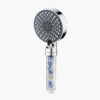 Modern shower head with multiple spray modes and a built-in filter system, featuring a transparent handle filled with filter beads for water purification.