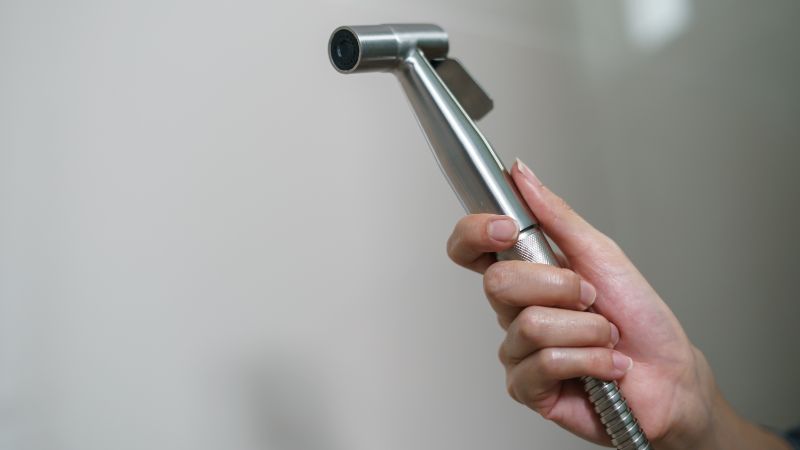 woman hand holding a bidet sprayer (1)