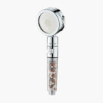 Handheld shower head with filter, clear handle, mineral beads, 6 spray modes; shown on a plain white background.