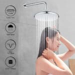 Une femme se tient sous une pomme de douche ronde de 25 cm dans une salle de bain moderne. Des icônes indiquent sa taille, son jet, son nettoyage et son filetage.