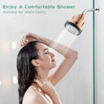 Shower head with rose gold finish delivering a relaxing spray, woman enjoying a shower, close-up of water flow, modern bathroom setting, luxury shower fixture.