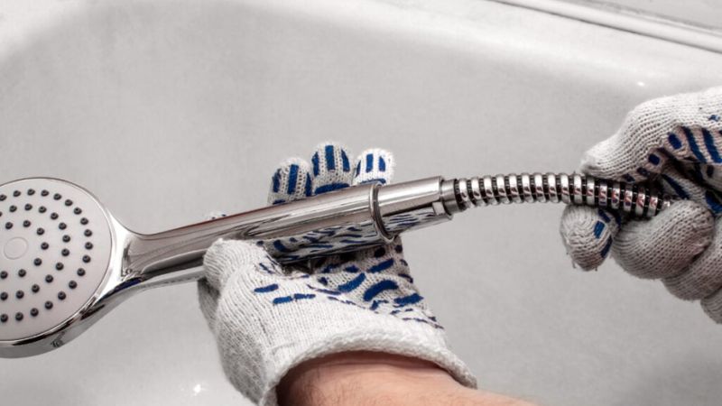 Chrome handheld showerhead with flexible hose, best for modern bathroom renovations and water-saving solutions.