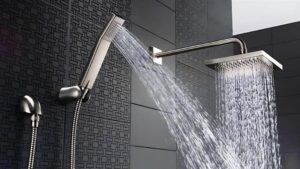 High-quality rainfall shower with handheld sprayer, modern chrome finish, and sleek black tile background for optimal relaxation and spa-like ambiance.