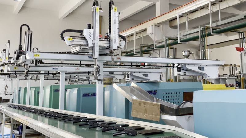 Modern glass manufacturing machinery in a factory setting, highlighting automation and precision in production processes.