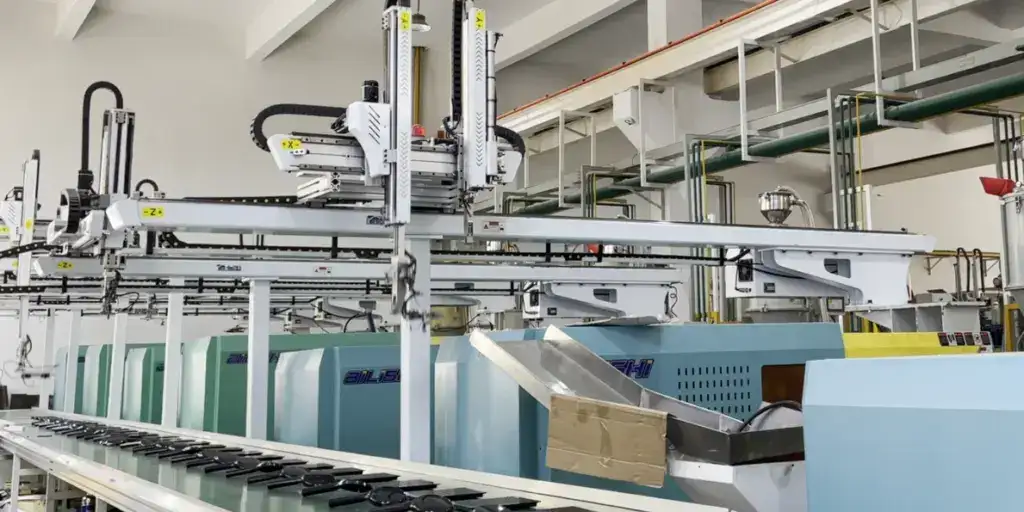 High-tech industrial manufacturing machinery in a factory setting with automated systems and conveyor belts.