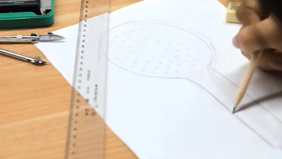 Person drawing a circular shape on paper using a pencil, ruler, and compass for precise measurements and design.